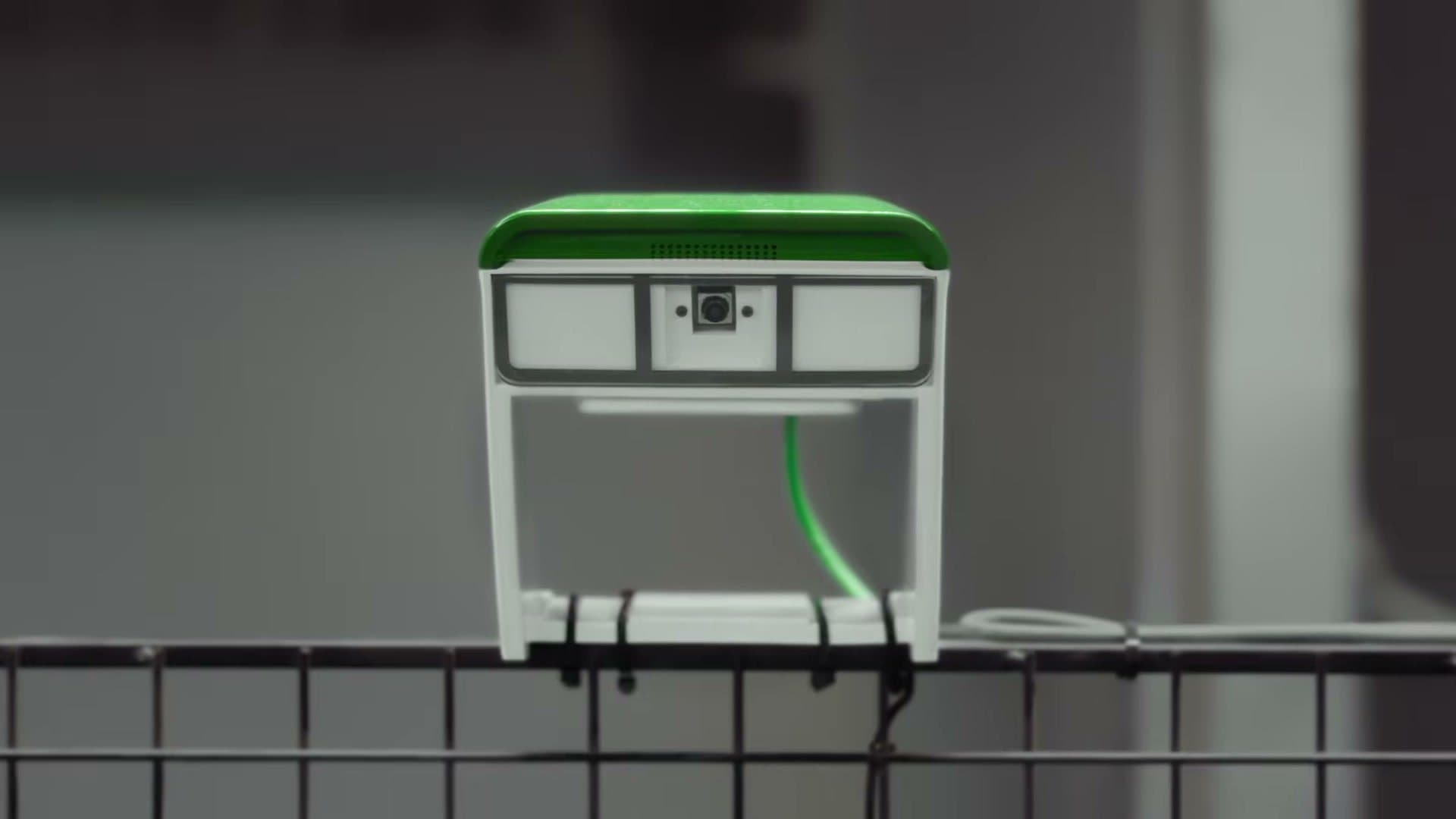 A Clutch Cam strapped to the back fence of a padel court