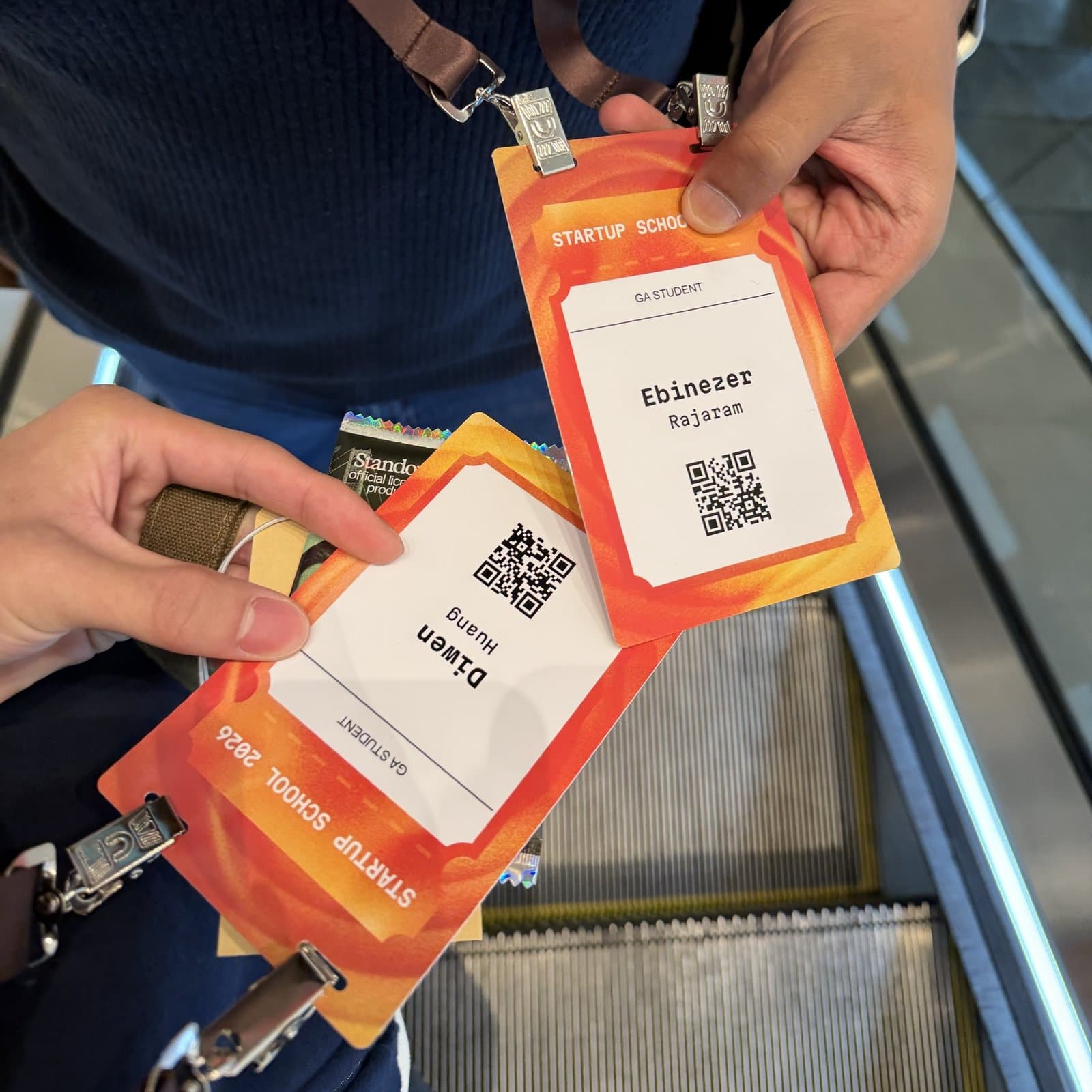 Two Startup School 2026 student badges
